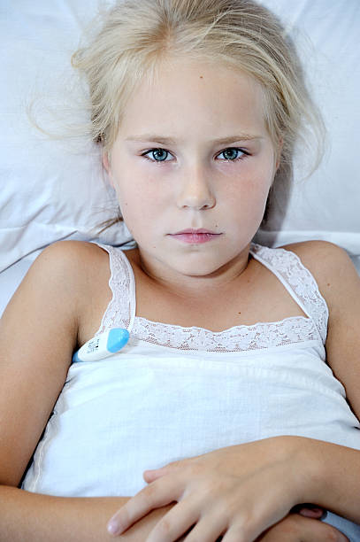 istock Little cute girl measures the temperature 499455318