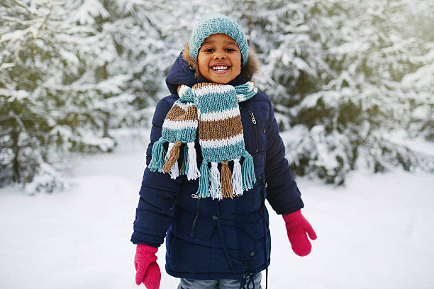 Happy kid Joyful kid in winterwear looking at camera in natural environment in winter children in winter stock pictures, royalty-free photos & images