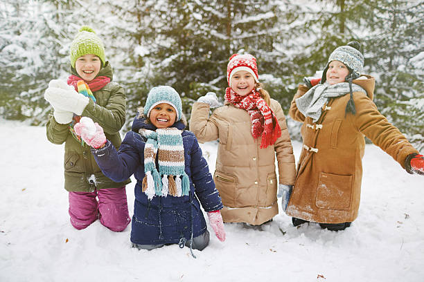 Snowball players Cute little friends playing snowballs in winter park snowball stock pictures, royalty-free photos & images