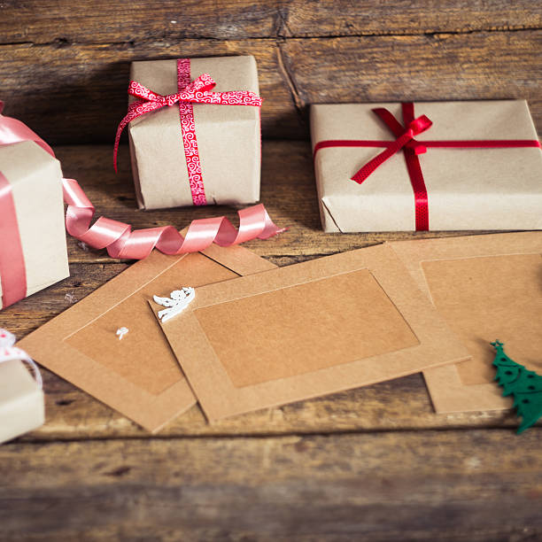 istock Christmas gift box with cards  on a wooden background 499458788