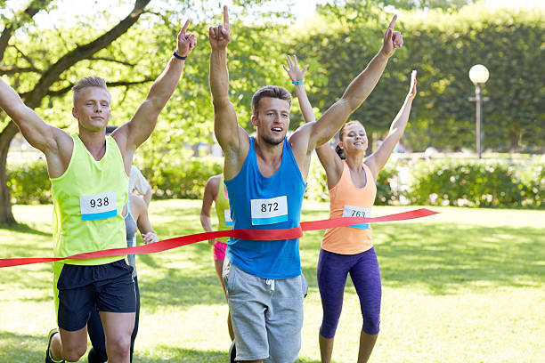 istock happy young male runner winning on race finish 499460968