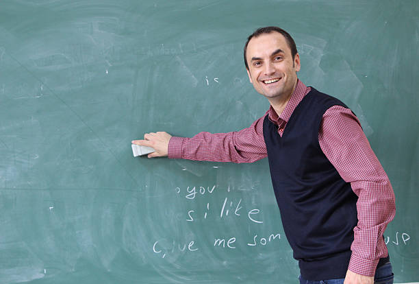 istock Teacher is cleaning board in the classroom. 499462540