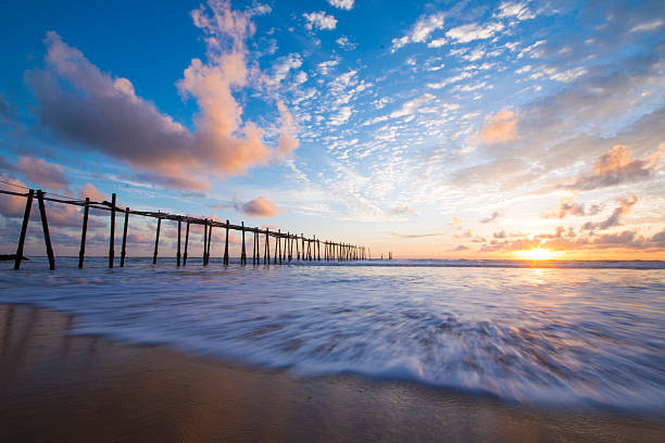 istock old wooden bridge in Natai beach with beautiful sky 499462916