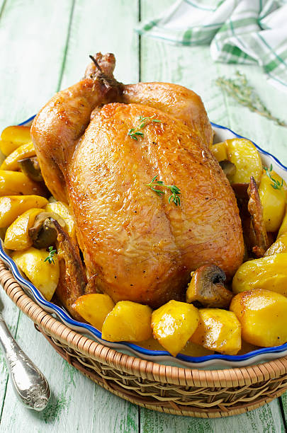 istock Whole roasted chicken with potatoes and mushrooms 499462986