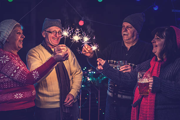 istock Mature friends having fun outdoors with sparklers 499463482