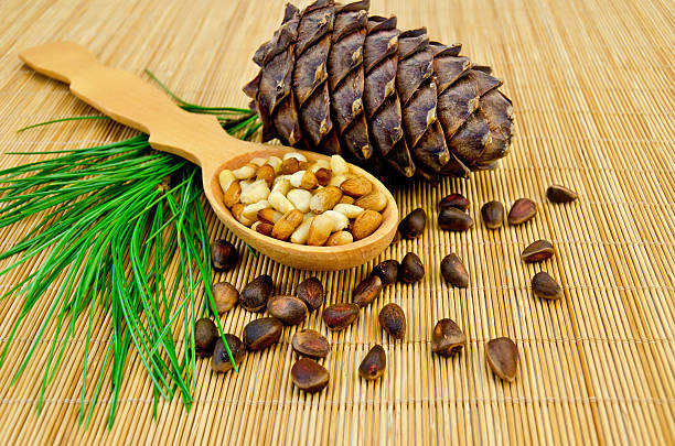 istock Nuts and cone of cedar on a bamboo mat 499464247