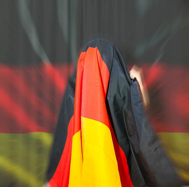 istock Little german supporter rejoices with flag on head 499465299