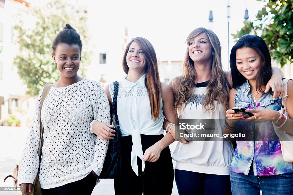 Four young women walking in the city Four young women walking in the city . 18-19 Years Stock Photo