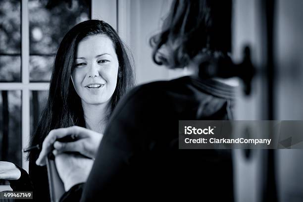 Young Woman Talking To A Colleague Stock Photo - Download Image Now - 30-34 Years, 30-39 Years, 35-39 Years