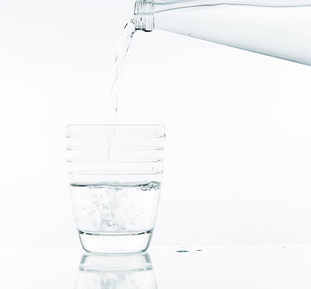 istock Pouring water on glass 499467309