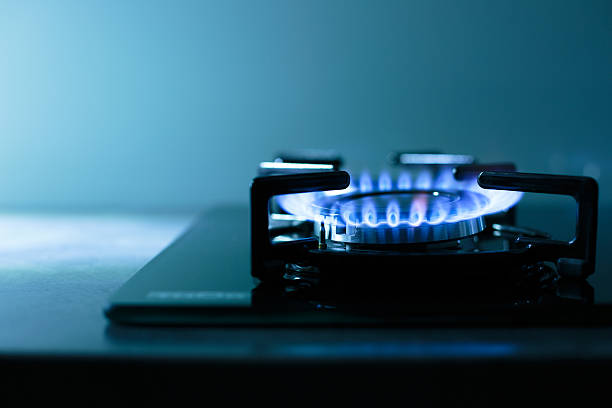 Flames of gas stove Ffames of dark gas stove/cooker (shallow DOF) cooktop stock pictures, royalty-free photos & images