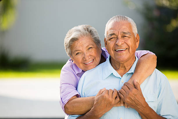 Loving senior couple hugging and posing stock photo