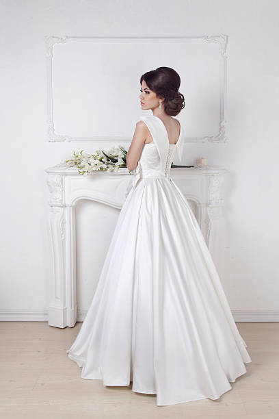 istock Beautiful charming bride in wedding luxurious dress posing 499470769