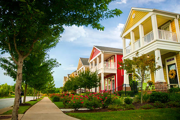 Row of colorful garden homes in suburban area Row of colorful garden homes with two stories and white pillars in suburban neighborhood of Fayetteville, Arkansas arkansas stock pictures, royalty-free photos & images