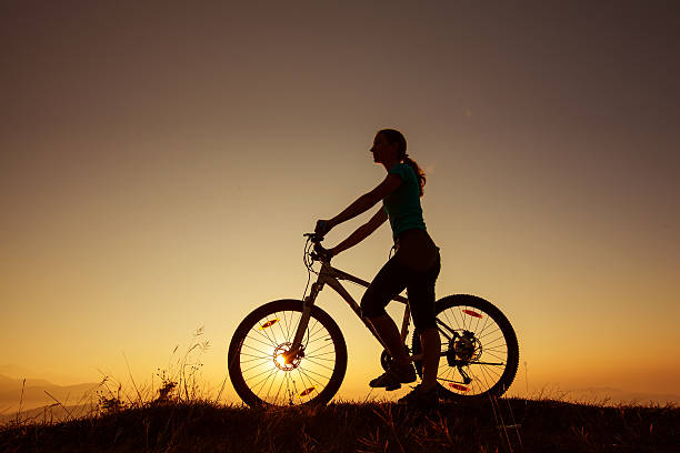 istock Biker-girl at the sunset on mountains 499476170