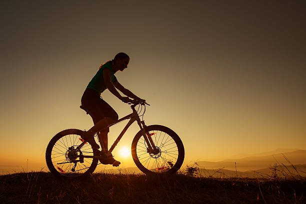 istock Biker-girl at the sunset on mountains 499476202