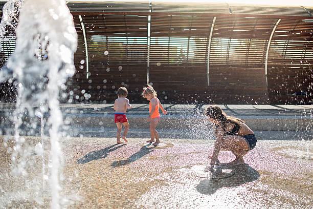istock Playful siblings having fun at fountain. 499479198