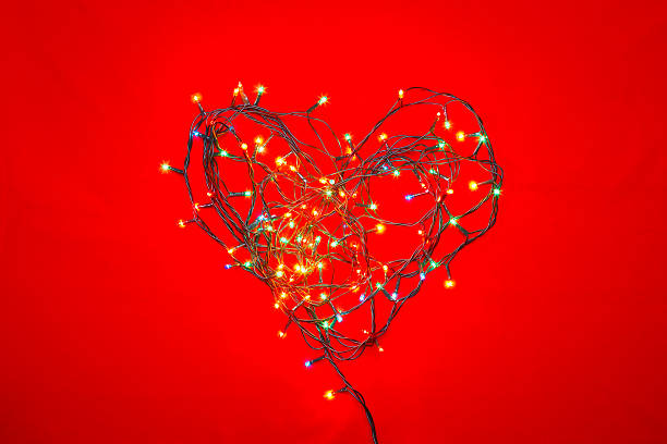 istock Heart shaped Christmas lights on red 499479886