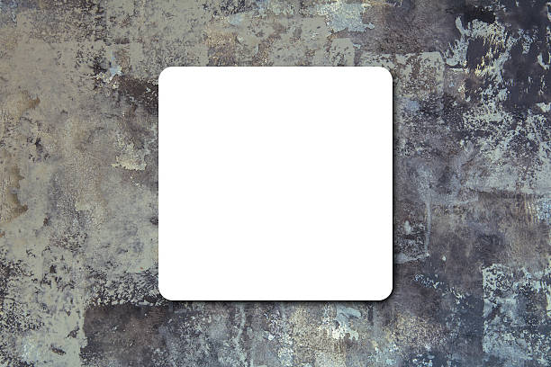 istock Black folded White paper poster hanging at black stone wall. 499480214