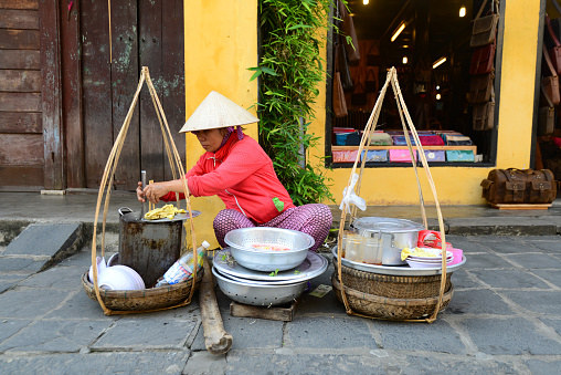 Hoian, Vietnam - January 24, 2015: Street vendor sell food in Hoian, Vietnam. Hoian is recognized as a World Heritage Site by UNESCO.