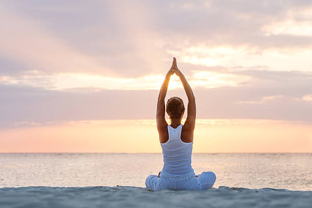 istock Caucasian woman practicing yoga at seashore 499480800
