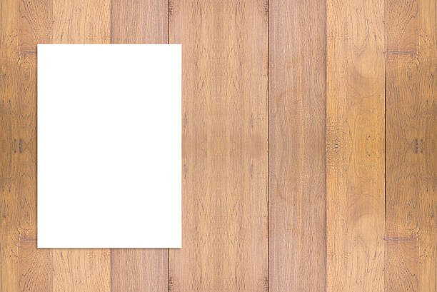 istock Blank folded paper poster hanging on wooden wall. 499480900