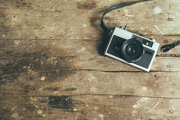 istock Vintage film camera on wooden table. 499481324