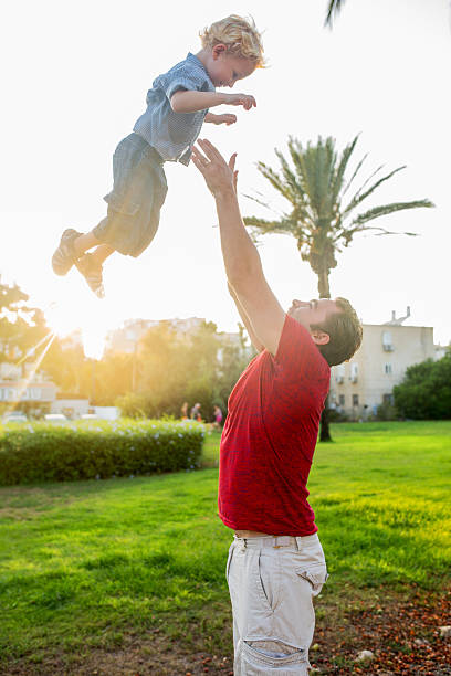 istock Happy father having fun with his son in the park. 499482312
