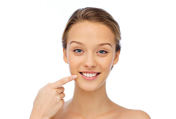 istock smiling young woman face and shoulders 499485116