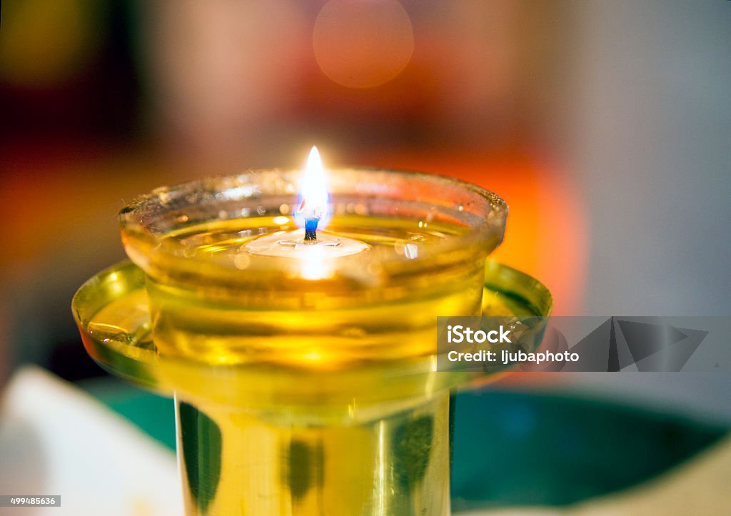 lamp for praying-icon lamp in church Candle, Hope - Concept, Human Hand, Praying, Spirituality,   Oil Lamp, Heat - Temperature, Love, Candle Indoors Stock Photo