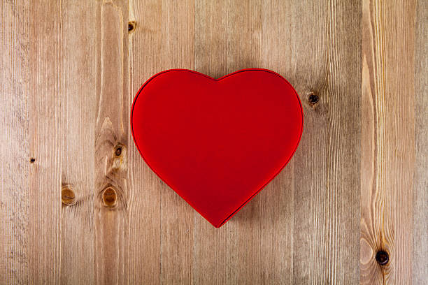 istock Heart-shaped Valentines Day gift box on wooden plates. 499486550