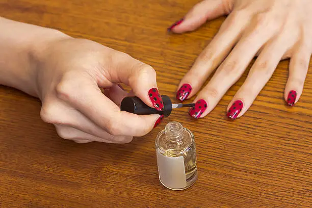 Photo of Women's hands,make the topcoat to the nails