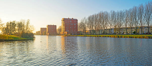 istock Highrise along a river at sunset in autumn 499490244
