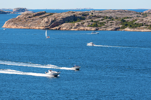 Rocky archipelago with motor boats at sea