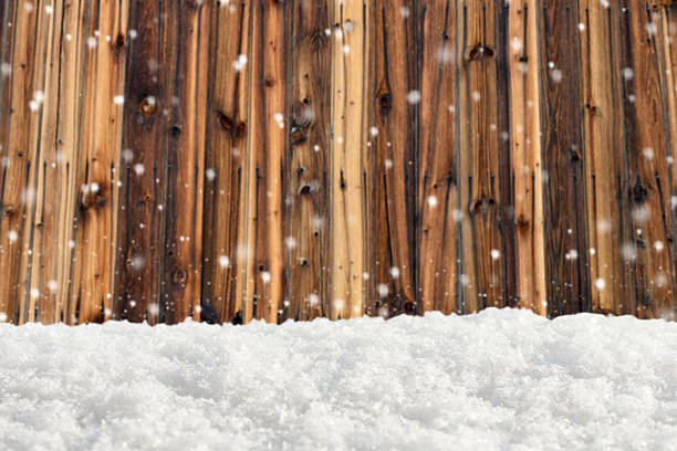 istock Snowdrift on the blurred background of wooden wall 499491096