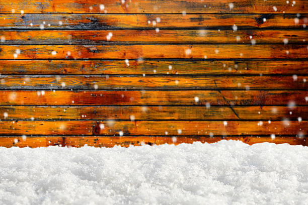Snowdrift on the blurred background of wooden wall