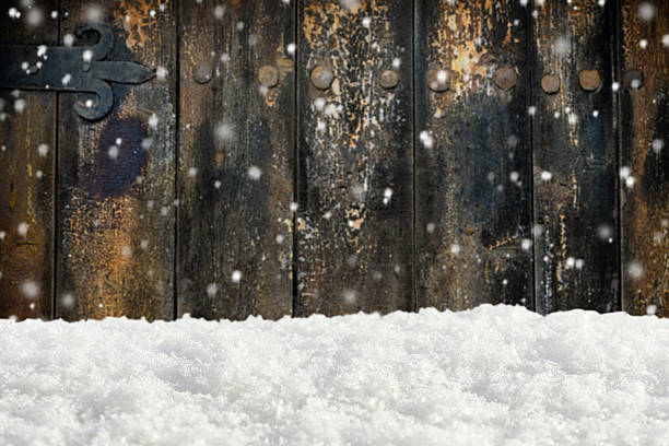 istock Snowdrift on the blurred background of wooden wall 499491426