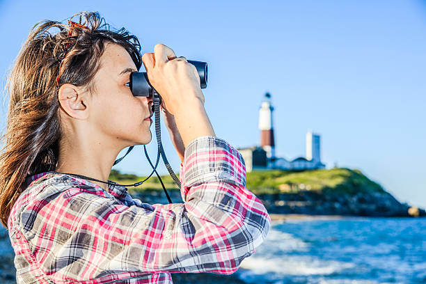 istock Teenage girl exploring ocean with binocular 499491611