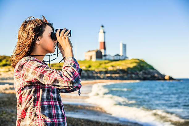 istock Teenage girl exploring ocean with binocular 499491629