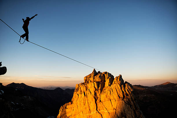 excite Slacklining in the mountains at sunset  record breaking stock pictures, royalty-free photos & images