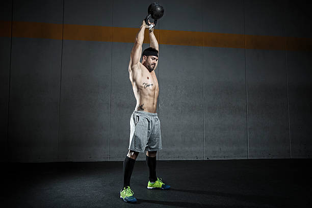 kettlebell swing crossift exercise with kettlebell ganar stock pictures, royalty-free photos & images
