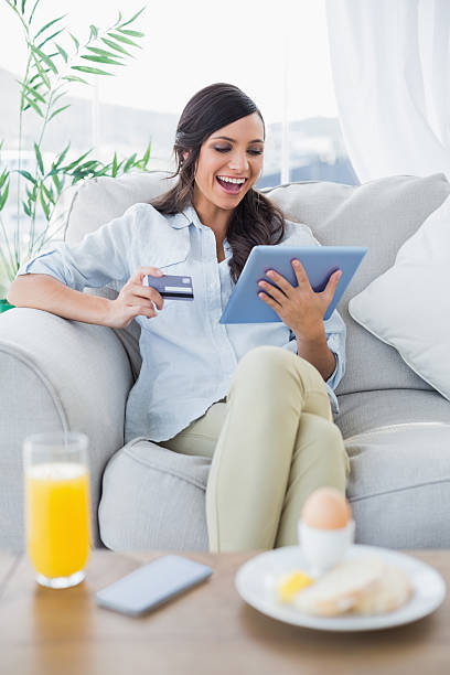 istock Cheerful gorgeous brunette buying online while having breakfast 499493829