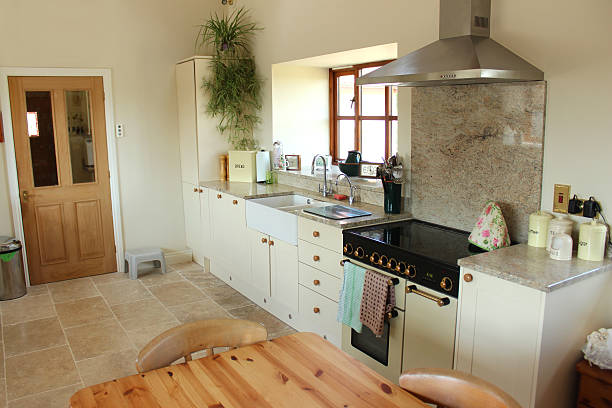 istock Country kitchen, granite worktop, gas range cooker, tiled-floor, pine table 499498105
