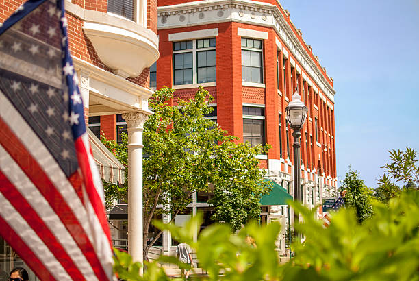 Downtown town square in Fayetteville, Arkansas American flag flying on the downtown Fayetteville square. arkansas stock pictures, royalty-free photos & images