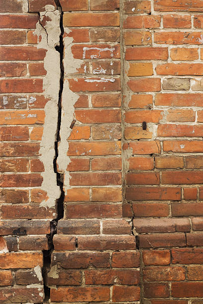 istock old cracked brick wall rough texture with light seams 499506874