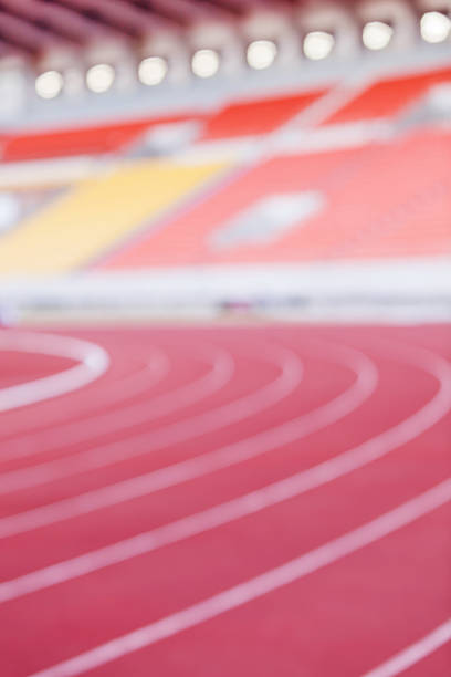 Abstract blurred background of empty athletic racetrack stadium.