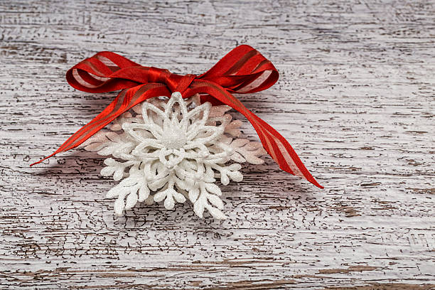 istock White snowflake figurine with red ribbon 499509854