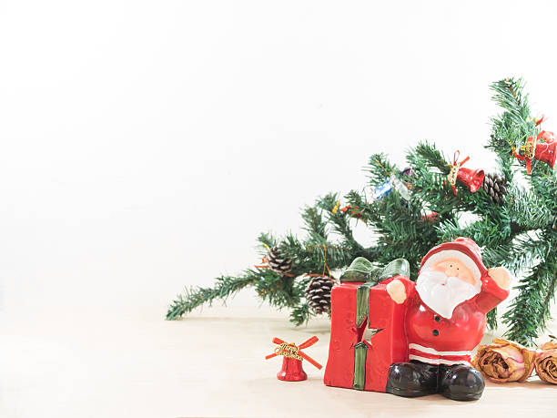 istock Santa claus with his gift present box and christmas tree 499510156
