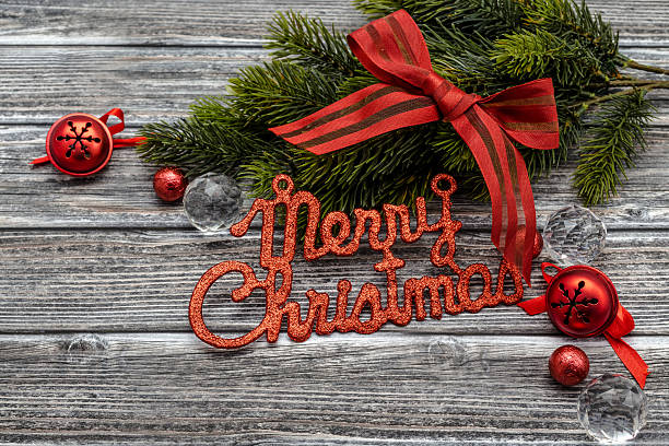 istock Merry Christmas text with decorations over wooden background 499510232