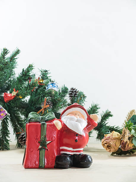 istock Santa claus with his gift present box and christmas tree 499510284